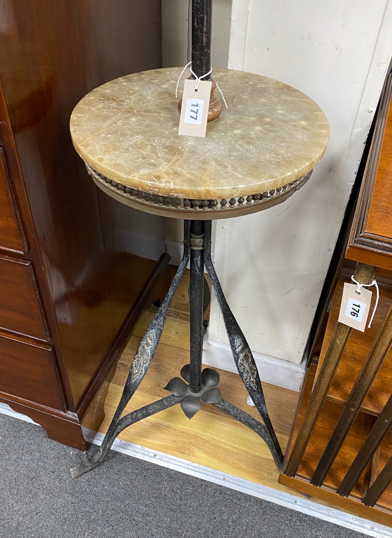 An Edwardian wrought iron and copper telescopic standard lamp with alabaster tier